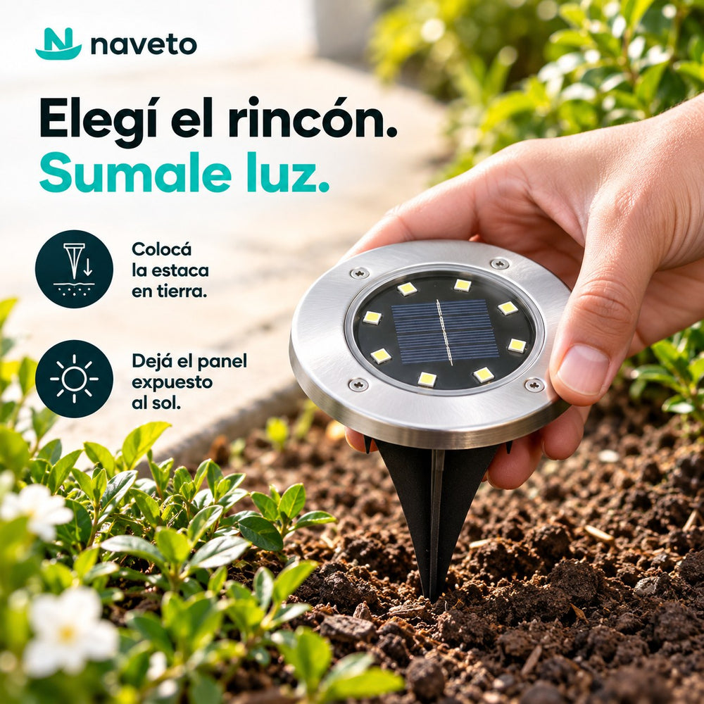 Mano clavando la luz solar en la tierra de un cantero