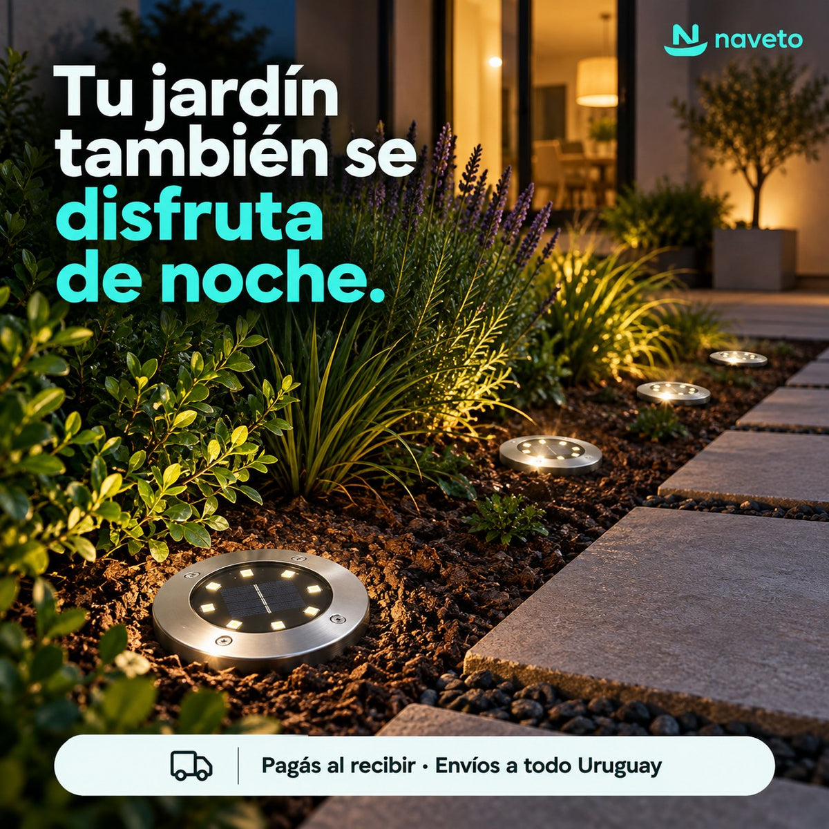 Jardín de noche con luces solares marcando el camino